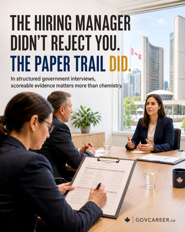 AI-generated GOVCAREER.ca graphic showing a structured government interview scene in a bright office overlooking Toronto City Hall and nearby towers, with a Canadian flag visible outside. Three panel members sit at a boardroom table while a candidate answers across from them. In the foreground, one panel member holds a clipboard with a scoring sheet, reinforcing that public-sector interviews are documented and evaluated against criteria. Large headline text reads: “The Hiring Manager Didn’t Reject You. The Paper Trail Did.” The phrase “The Paper Trail Did” is highlighted in blue and gold. Supporting text reads: “In structured government interviews, scoreable evidence matters more than chemistry.” GOVCAREER.ca branding appears at the bottom with a maple leaf icon. The visual communicates that government and public-sector hiring decisions rely on documented evidence, scoring rubrics, and defensible evaluation rather than chemistry or informal impressions. Generated by an AI tool.